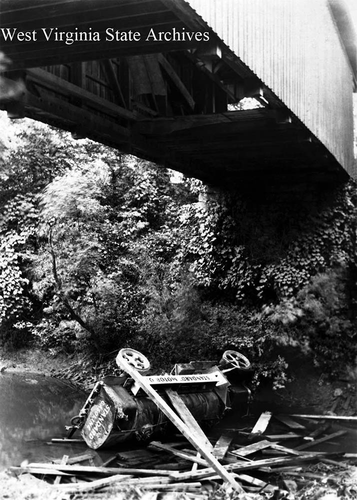 Standard Oil Company gasoline truck wreck. It  fell through the covered bridge over French Creek, between Hampton and Sago in Upshur County. Ray A. Tenney at the wheel, September 26, 1928. Photograph by Horace R. Clark. Upshur County Historical Society Purchase Collection, West Virginia State Archives (308406)