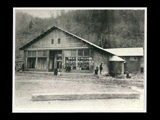 Exterior view of the store at Caretta with several people outside. This picture is also found in the DeHaven Collection, Roll 1599 06.