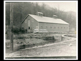 New barn. Wooden bridge over creek under construction.