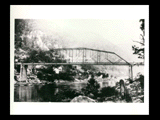 Bridge across the New River at Fayette Station. Houses on the hillside in the background.