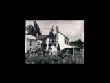 "Holmefield," house on mountain. A two-story frame house with a garden in the foreground.