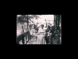 Martha, Minnie, and Jackson Taylor sitting in chairs on porch at Swarthmore, PA. Martha is in a wicker rocking chair, Jackson in a regular rocker.