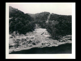 Power house site during the hydroelectric power construction on the New River. Beginning of tunnel shown in center of picture. The cribs in foreground are foundations for derricks and hoisting machinery for placing concrete in power house. New-Kanawha Power Company, Hawks Nest - Gauley Junction Development No. 110.