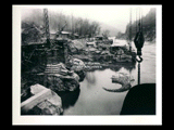 Power house site during the hydroelectric power construction on the New River. View shows power house construction work halted by flood water amounting to approximately 30,000 c.f.s. Partially completed scroll case for unit No. 3 shown in center of picture. Penstock excavation shown at left. New-Kanawha Power Company, Hawks Nest - Gauley Junction Development No. 217.