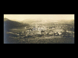 View of Barrackville from hillside. Wood fence in foreground.